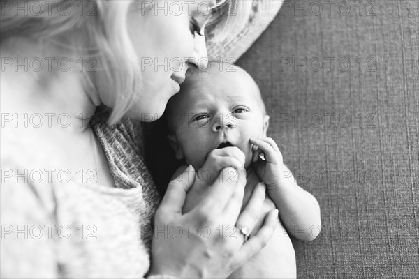 Mother holding one day son (0-1 months)