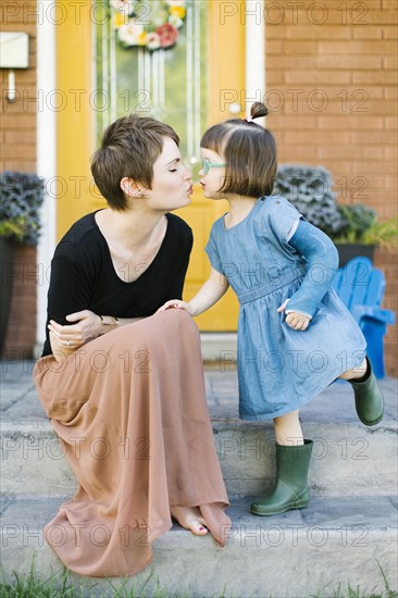 Mother kissing daughter (2-3)