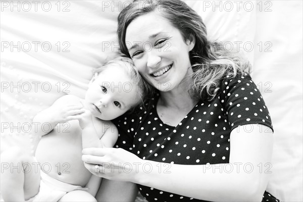 Portrait of baby girl (6-11 Months) with mother, directly above