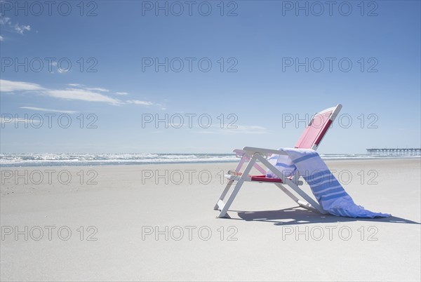 Deckchair on empty beach