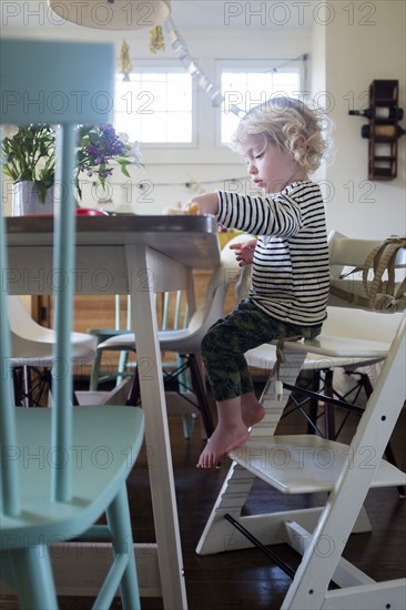 Boy at table on step ladder