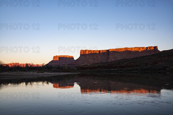 Cliffs by Colorado River at sunset in Utah, USA