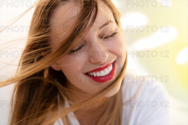 Portrait of windswept young woman wearing red lipstick