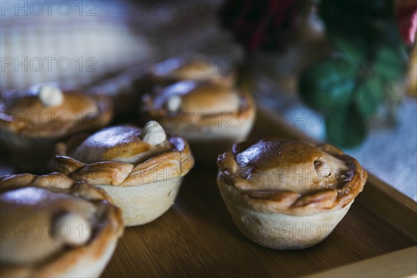 Chicken pies on wooden tray