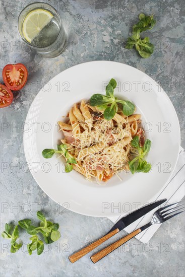 Pasta topped with cheese and basil
