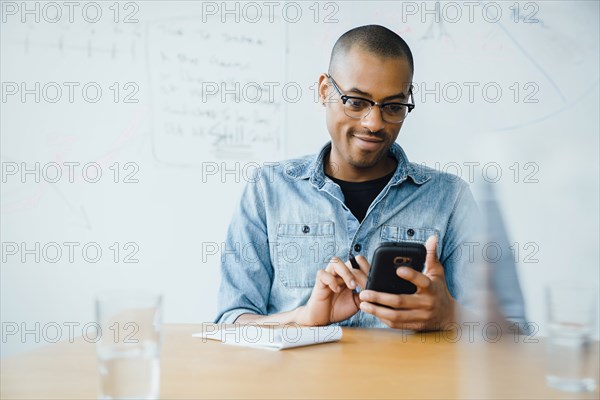 Man using smart phone in office