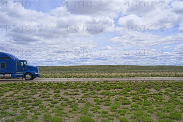 Blue truck on rural highway in Wyoming