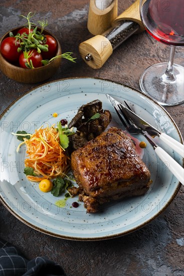 Grilled meat with salad by glass of red wine