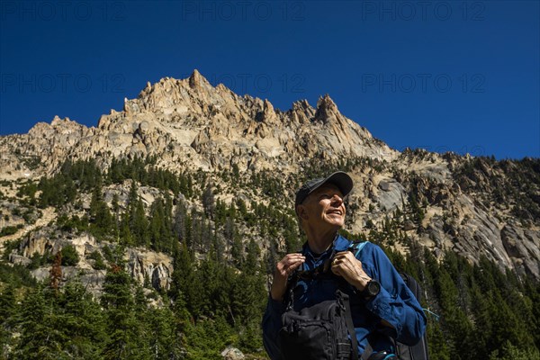 Smiling man hiking on Sawtooth Mountains in Stanley, Idaho, USA