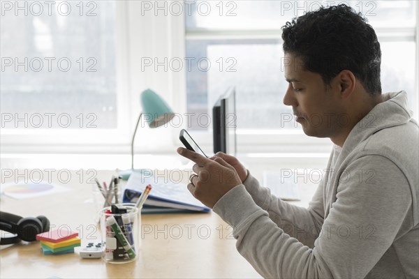 Businessman using smart phone in office