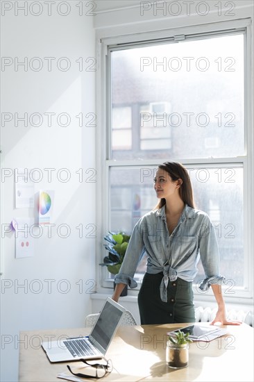 Business woman standing behind office desk