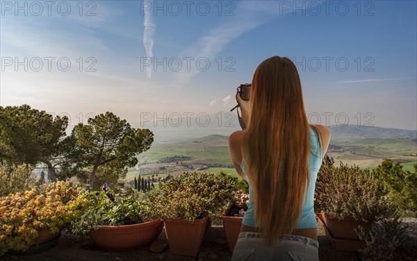 Woman taking photograph of hills