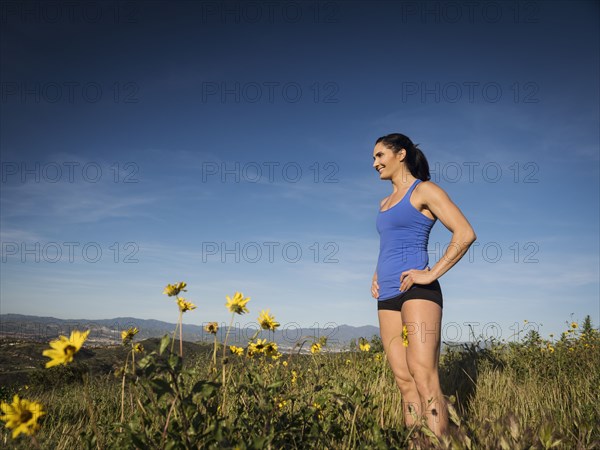 Woman in sportswear standing in meadow