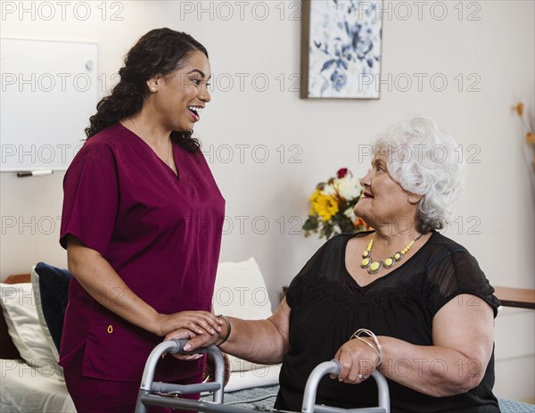 Nurse talking to senior woman in nursing home