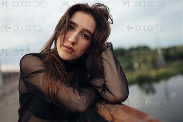 Belarus, Brest, Portrait of young woman on bridge over river