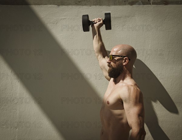 Man exercising with dumbbell