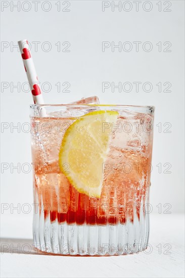 Aperol spritz with lemon and straw