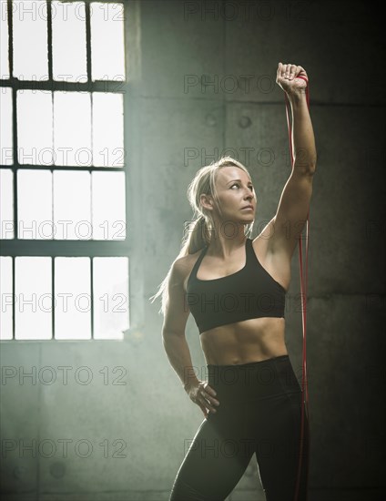 Woman exercising in warehouse