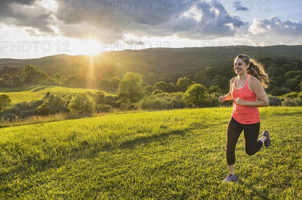 USA, Woman running in field