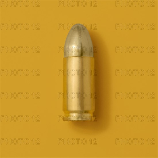 Gold bullet on yellow background