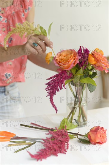 Woman making floral arrangement