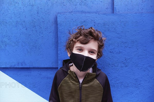 Boy (8-9) wearing protective face mask