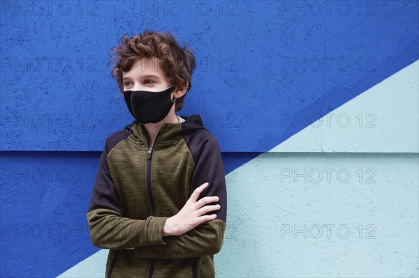 Boy (8-9) wearing protective face mask