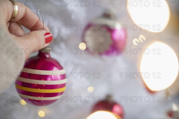 Hand decorating Christmas tree