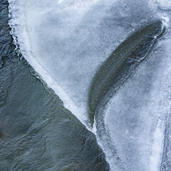 Edge of ice along river in winter