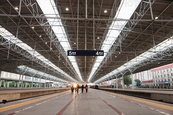 People on Beijing train station platform