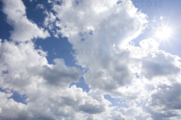 Sunburst through clouds in sky