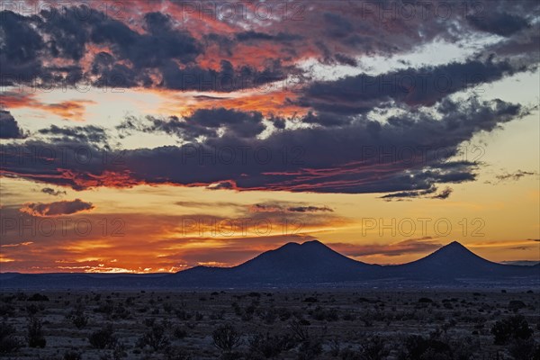 Cloudy sky over desert landscape at sunset