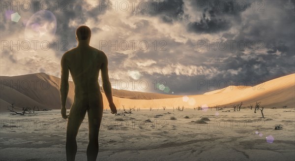 Naked man standing in desert