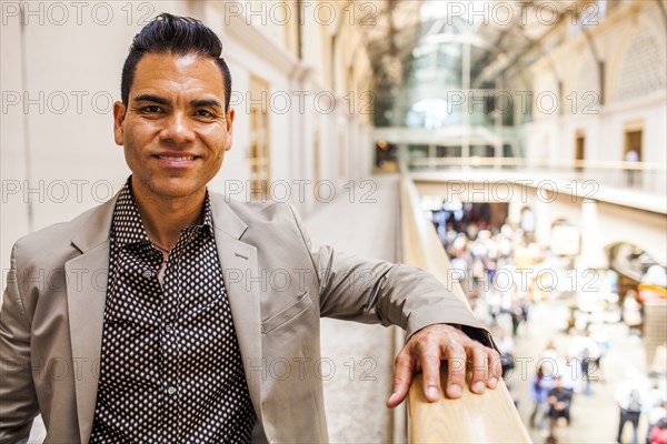 Hispanic businessman standing on upper level