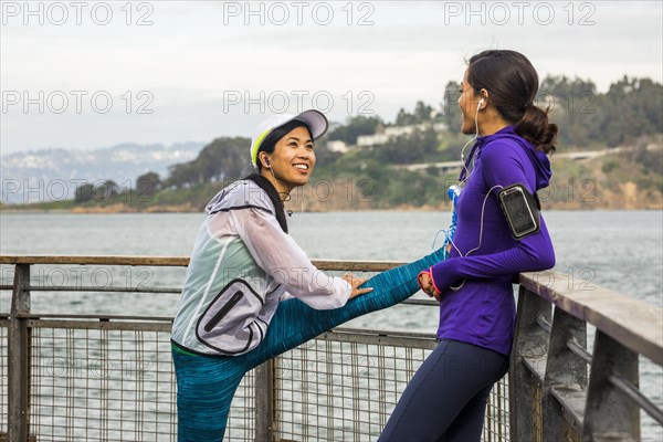 Runners stretching at waterfront