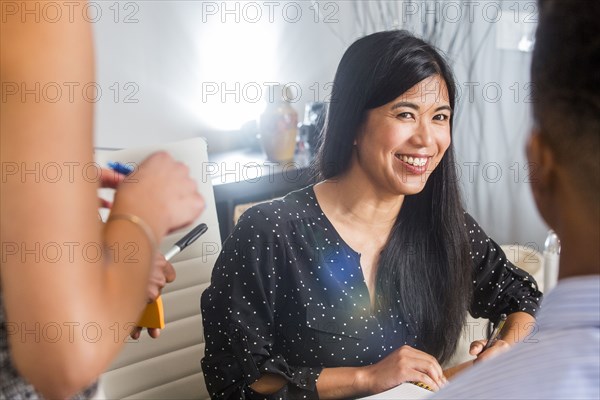 People smiling in business meeting