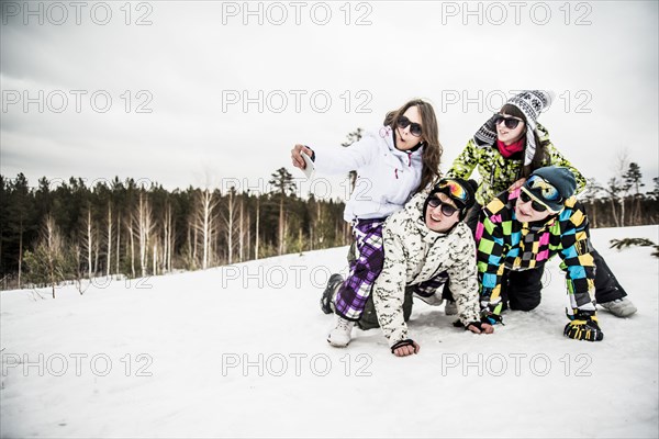 Caucasian friends smiling in snow