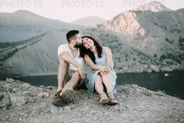 Caucasian man kissing woman on forehead at lake