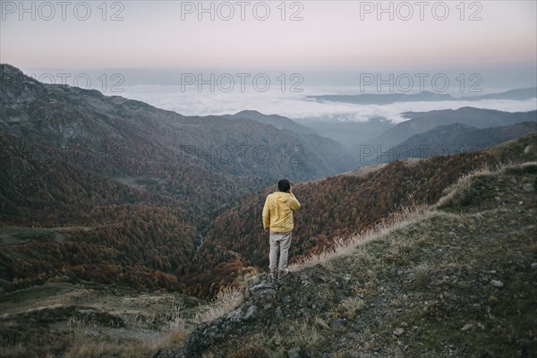 Caucasian man standing in remote mountain landscape