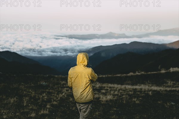 Caucasian man standing in remote mountain landscape