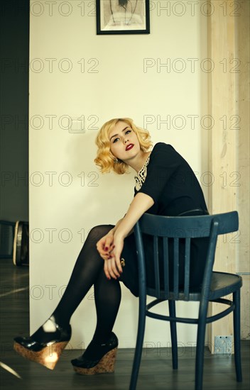 Caucasian woman sitting in wooden chair