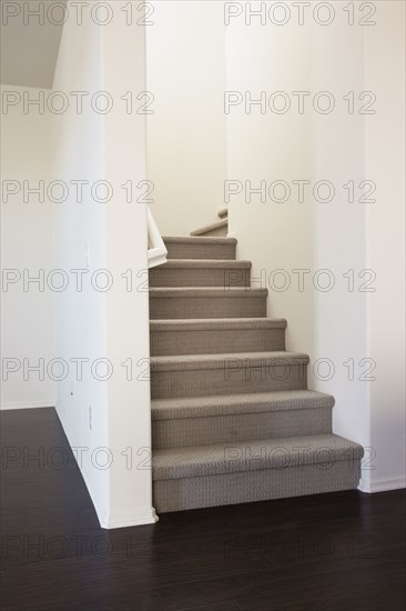 Close-up of stairs with white walls at home