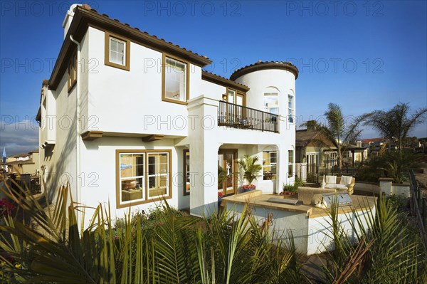 Rear exterior of one story house with patio against clear blue sky