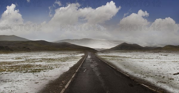 Empty road in snowy rural landscape