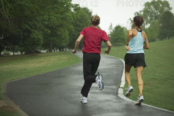 Runners jogging in park