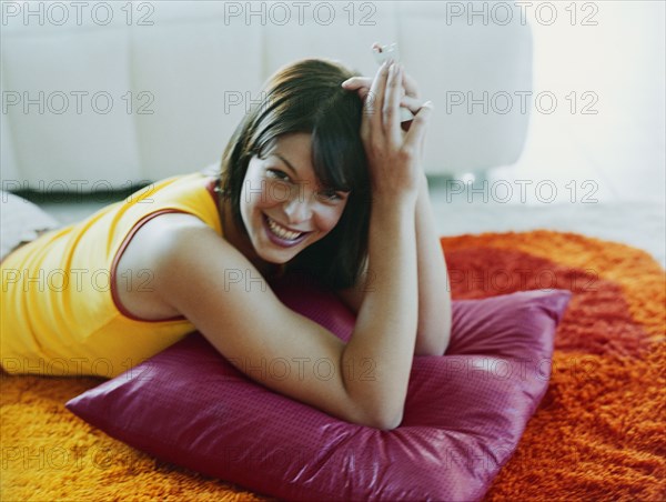 Woman laying on pillow on floor