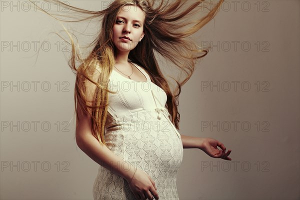 Pregnant woman with windblown hair