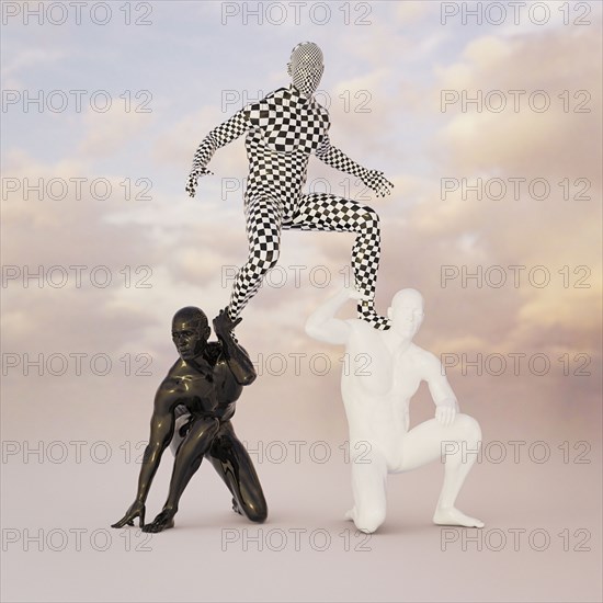 Checkered man balancing on shoulders of black and white men