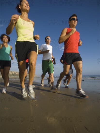 Multi-ethnic runners racing at beach