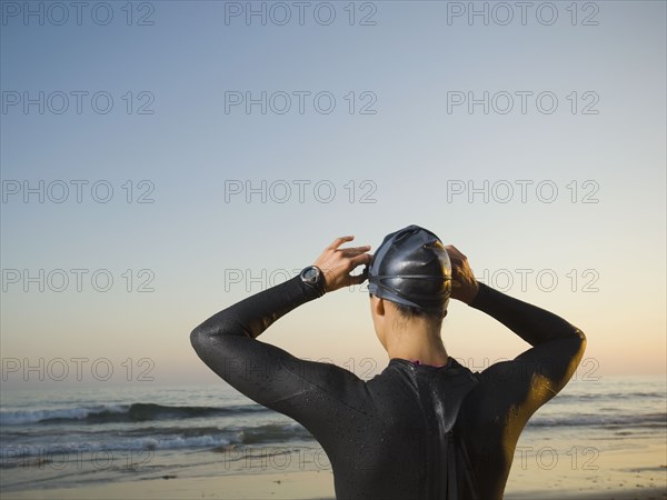 Rear view of Hispanic woman wearing wetsuit